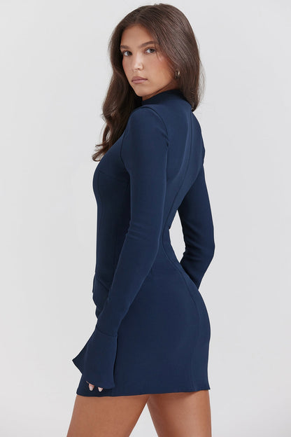 Full-length front view of a navy long sleeve high neck mini dress with flared cuffs and pocket details.
