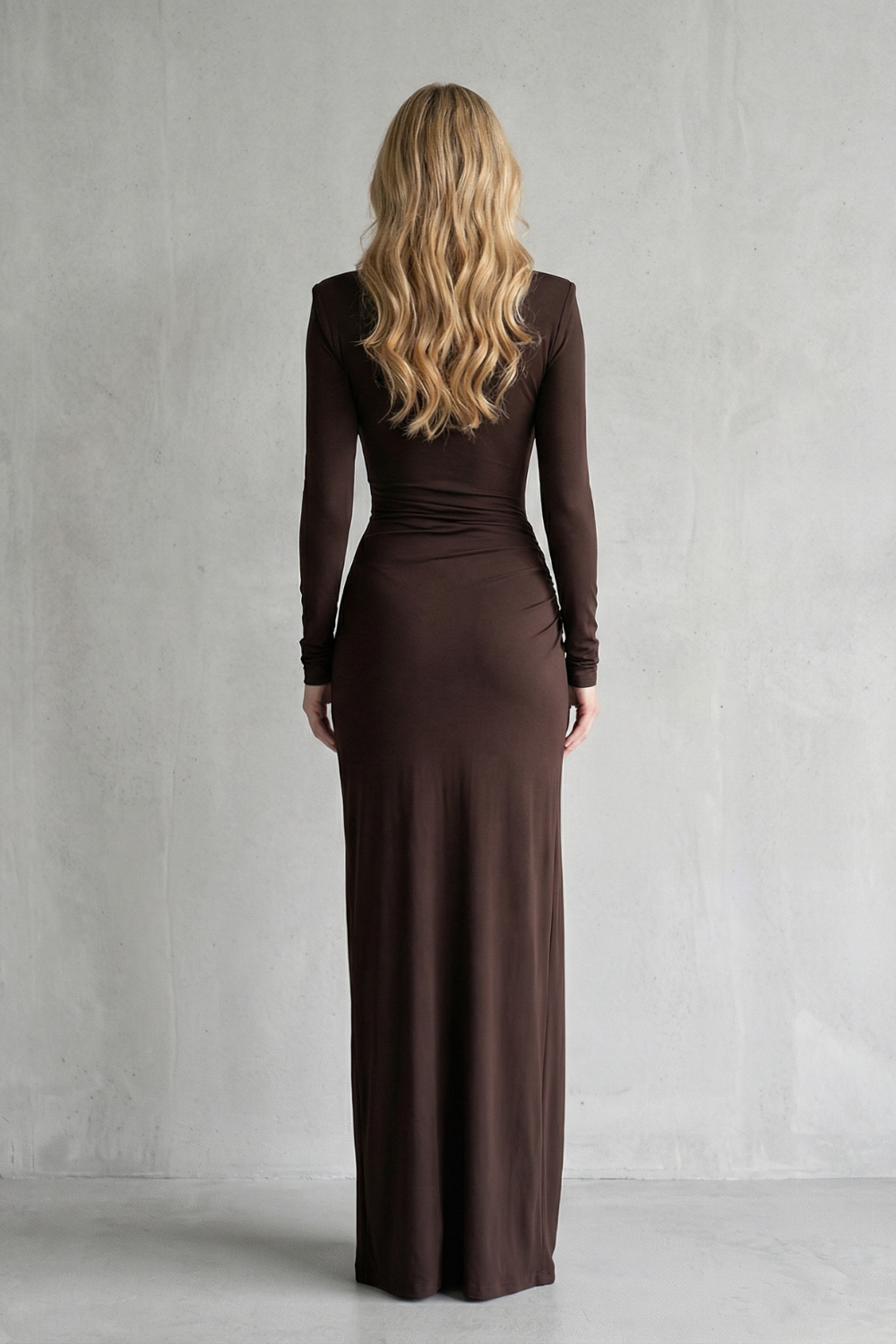 Back view of a brown long sleeve high neck maxi dress, showing the full length and fitted silhouette