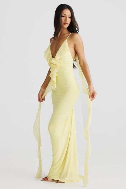 Side view of a yellow low back maxi dress with a ruffled bodice and flowing straps, a stunning vacation dress.