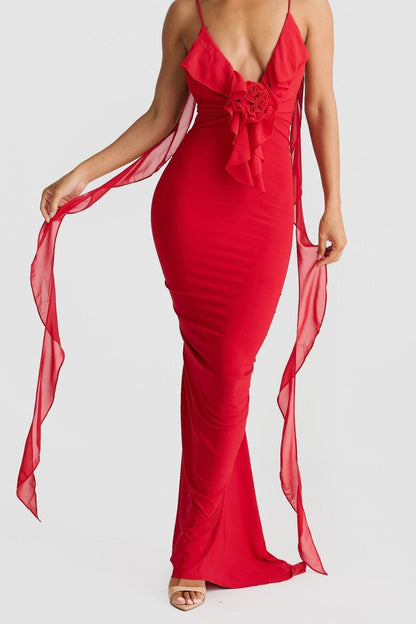 Side view of a red low back maxi dress, highlighting the flowing shoulder straps and bodycon silhouette.