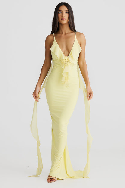 Front view of a yellow low back maxi dress with a ruffled bodice and rose feature, perfect for vacation dresses.