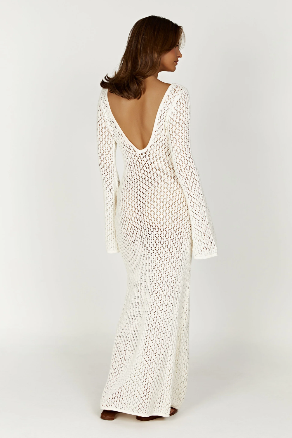 Back view of white open-knit crochet maxi beach dress with deep V back and long sleeves