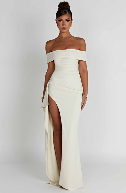 Elegant white off-shoulder pleated maxi dress with a high slit, front view, perfect for a formal occasion.