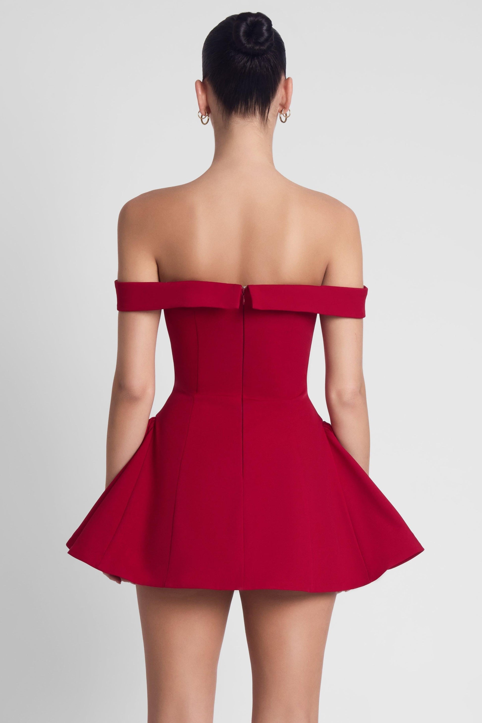 Back view of burgundy off shoulder sweetheart corset babydoll mini dress with center zipper detail