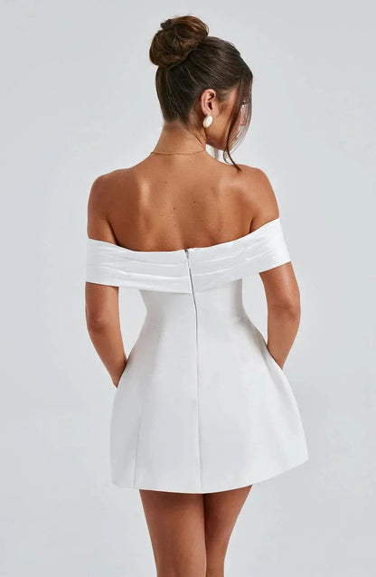 Back view of women's white off-shoulder mini dress, showcasing the zipper detail and the fitted silhouette without the bow.