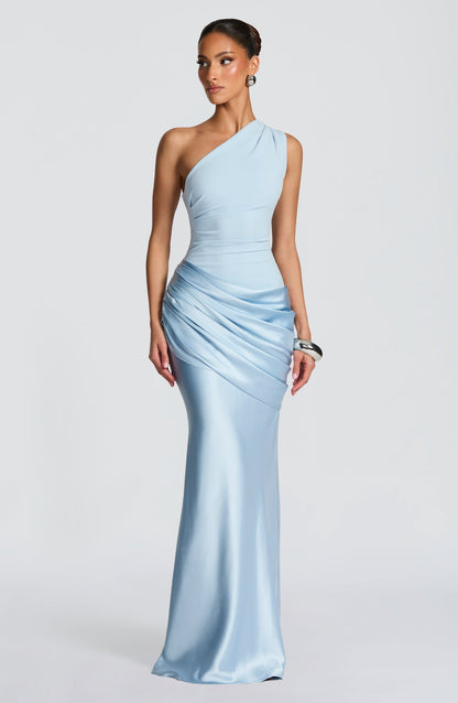 Women's light blue one-shoulder draped formal maxi dress, showing the elegant satin fabric and ruched waist detail.