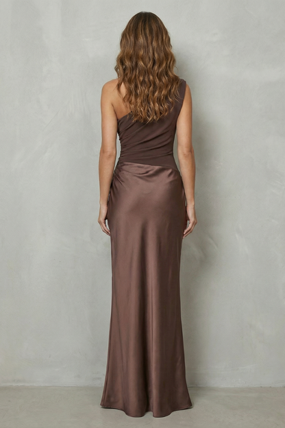 Back view of the brown one-shoulder draped satin maxi dress, showing the smooth satin fabric and the single shoulder strap.