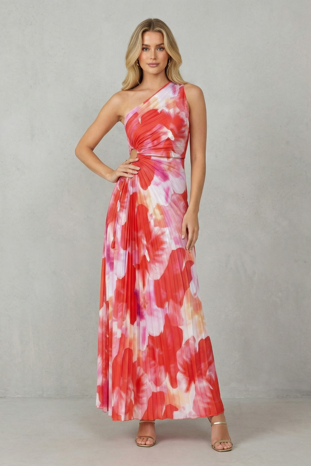 Women red and pink floral maxi dress with one-shoulder and side cut-out detailing on a grey wall background