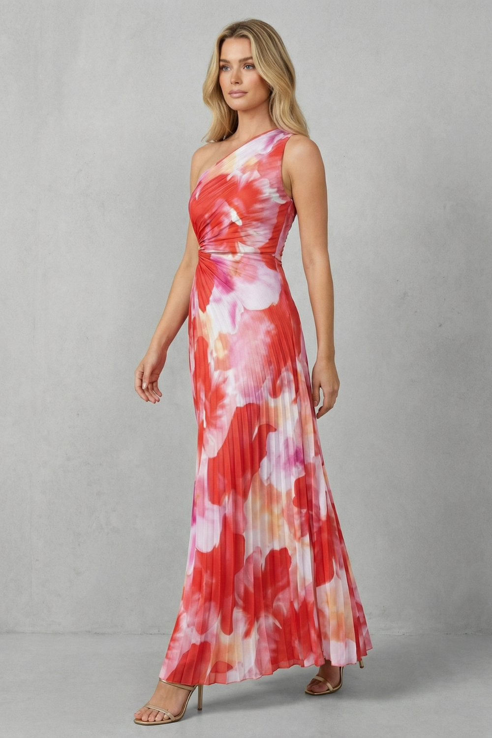 Women red and pink floral maxi dress with pleated skirt walking pose on a grey background