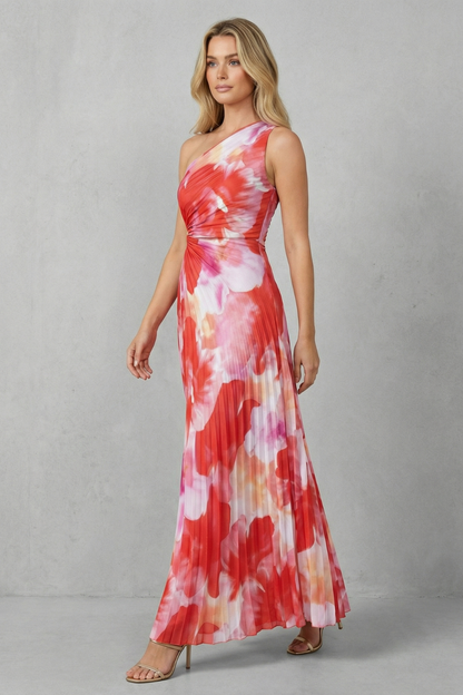 Women red and pink floral maxi dress with pleated skirt walking pose on a grey background
