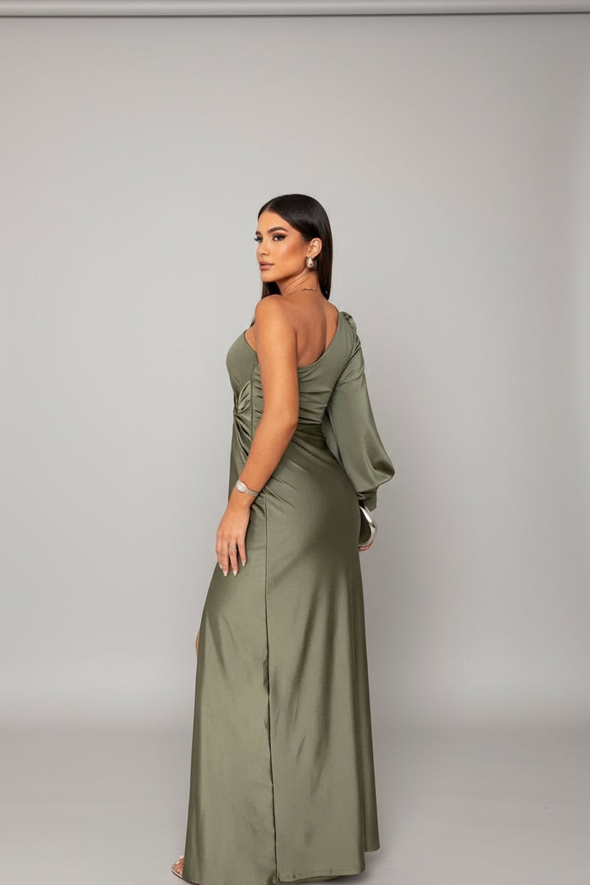 Back view of the olive green one-shoulder maxi dress, highlighting the long sleeve and flowing skirt.