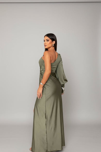 Back view of the olive green one-shoulder maxi dress, highlighting the long sleeve and flowing skirt.