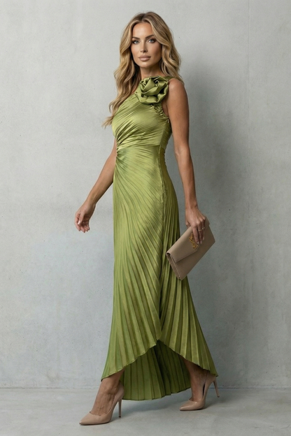 Side profile of a woman wearing a flowing olive green one-shoulder pleated maxi dress, perfect for wedding guests.