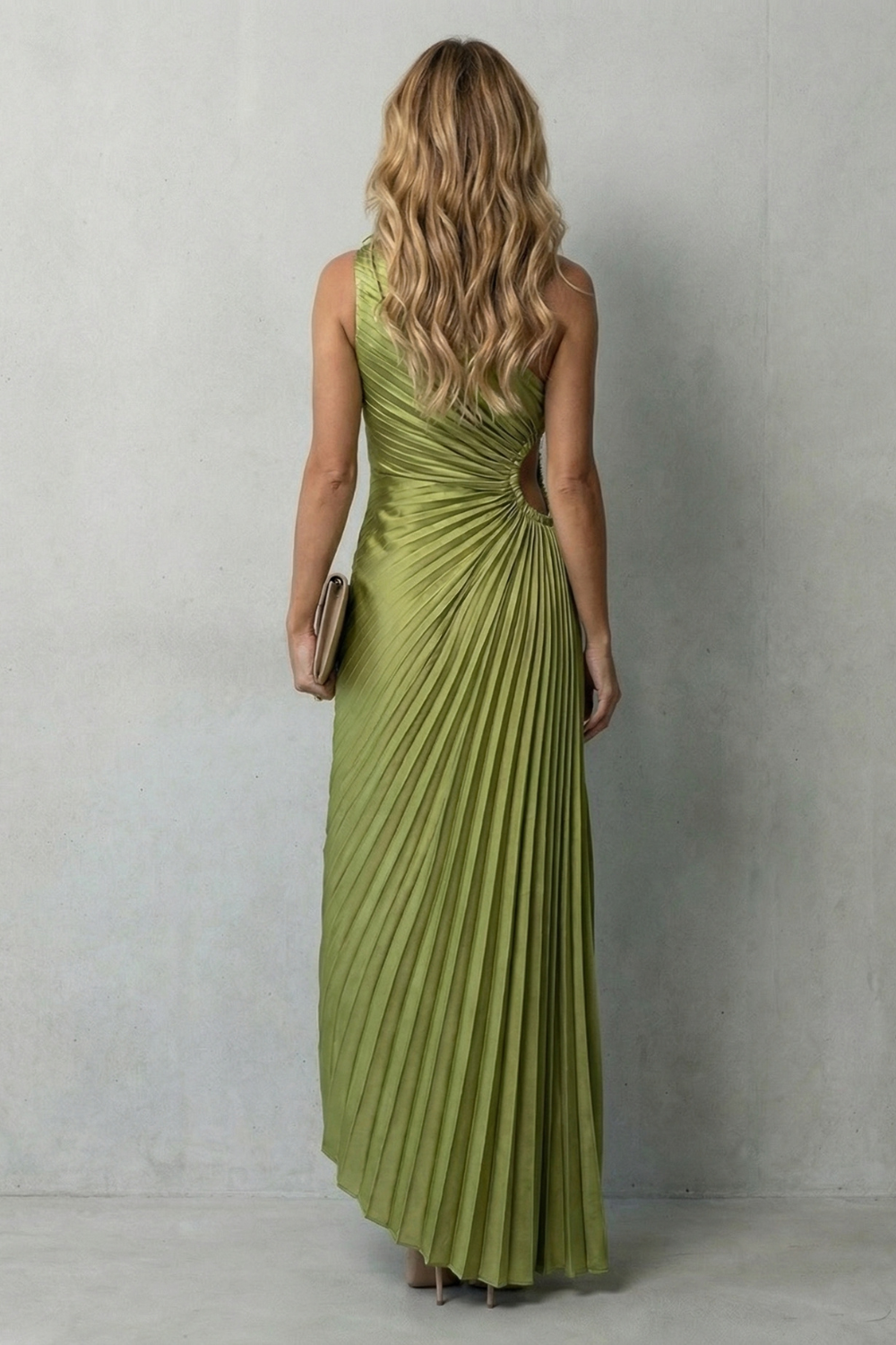 Back view of the olive green one-shoulder pleated maxi dress, showcasing the intricate pleating and cut-out detail.