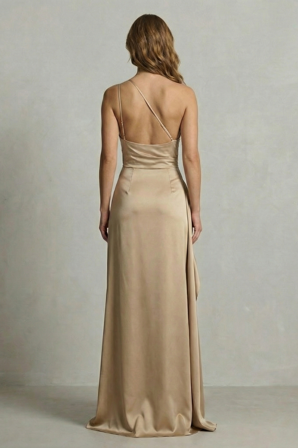 Back view of a champagne satin one shoulder maxi dress, highlighting the delicate strap and smooth fabric.