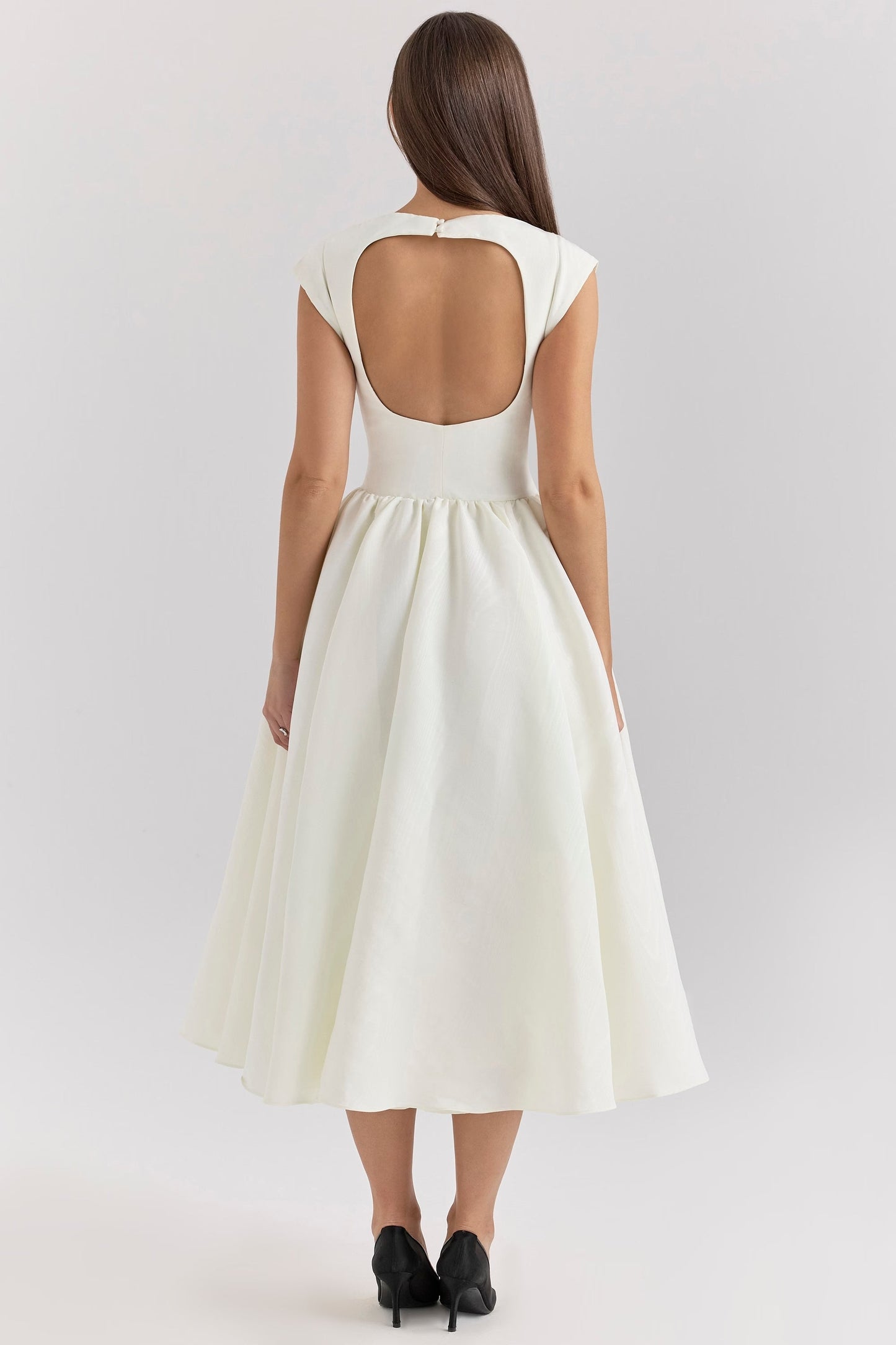 Back view of a white open back square neck midi dress with a keyhole detail and flowing skirt.