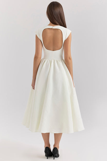 Back view of a white open back square neck midi dress with a keyhole detail and flowing skirt.