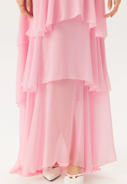 Close-up of the lower tiers of the pink ruffle maxi dress, showing the sheer fabric and layered design.