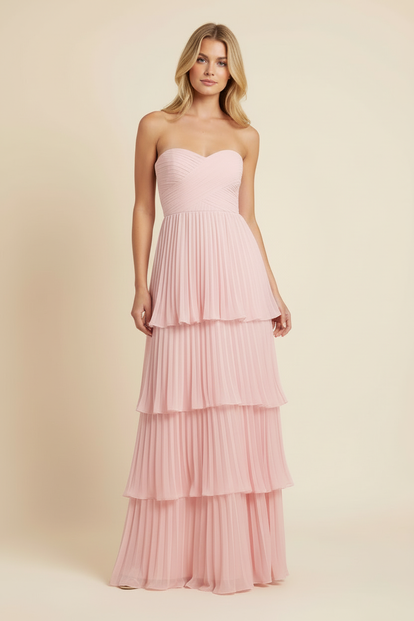 Front view of a women's light pink strapless tiered maxi dress with a fitted ruched bodice and pleated skirt