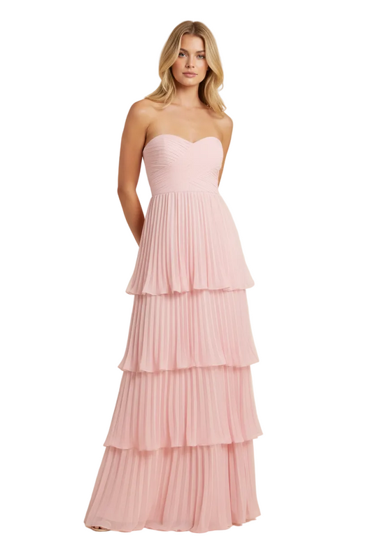 Light pink strapless tiered maxi dress with a sweetheart neckline and pleated layers, hands behind back pose