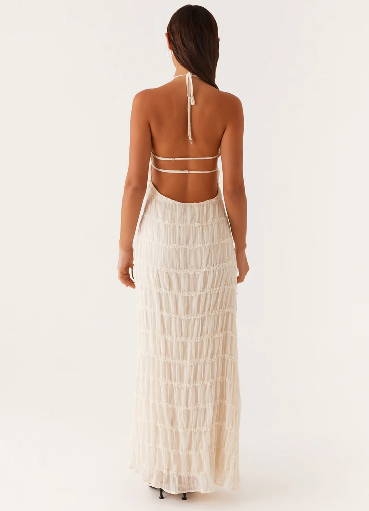 Ivory halter maxi dress back view with open back straps and sheer tiered skirt to ankle length