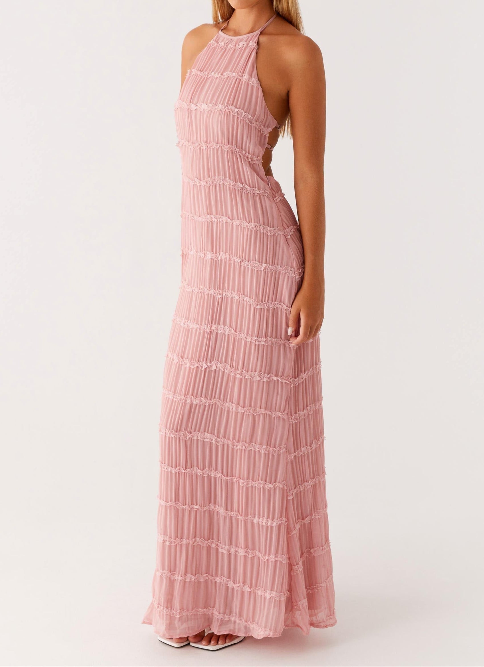 Blush pink pleated halter maxi dress close-up showing lace tier details and side cutout