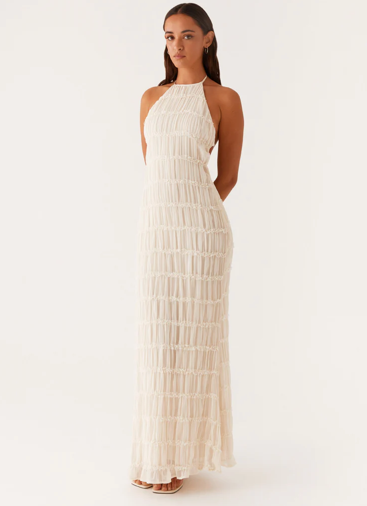 Ivory pleated halter maxi dress with lace trim tiers and floor-length hem, front view