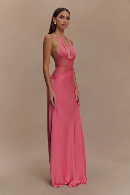 Side view of a women's vibrant pink halter V-neck maxi dress, showing the flowing silhouette and deep V neckline, ideal for wedding guest dresses.