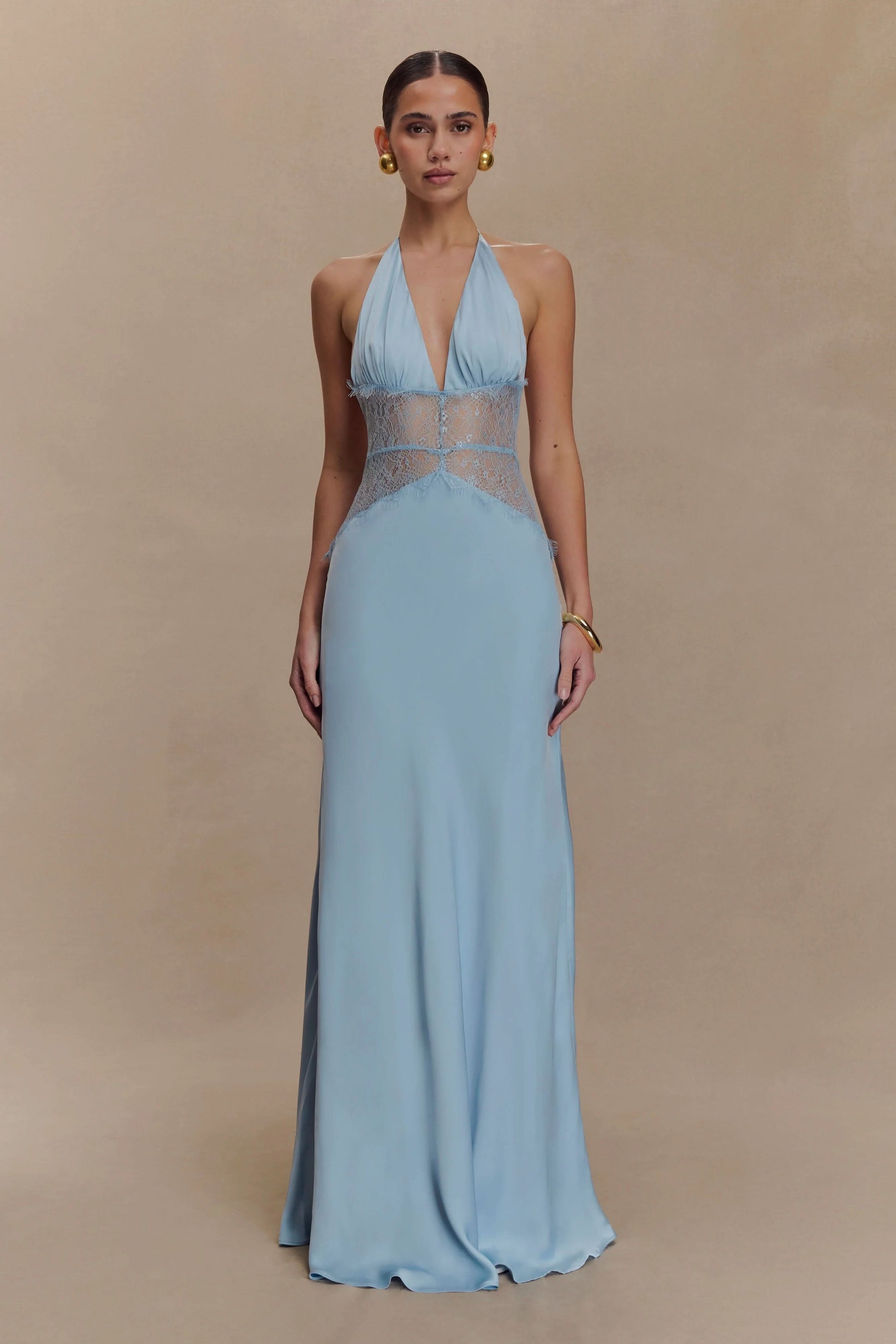Front view of a women's light blue halter V-neck maxi dress with delicate lace inserts, suitable for a beach dress or vacation outfit.