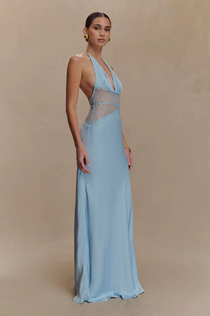 Side view of a women's light blue halter V-neck maxi dress, showcasing the elegant drape and lace detailing, perfect for a midi dress with sleeves alternative.