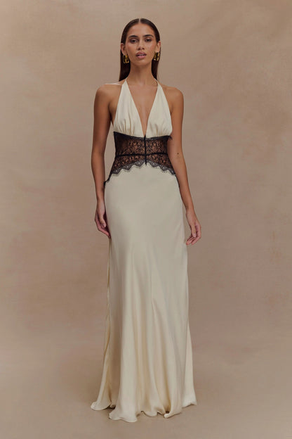 Front view of a women's cream halter V neck maxi dress with black lace bodice detail, a sophisticated vacation dress.