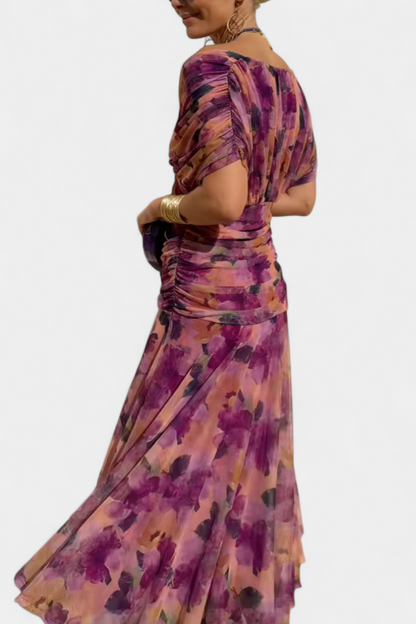 Side view of purple printed off shoulder ruched maxi dress with gathered sleeves and flowy skirt