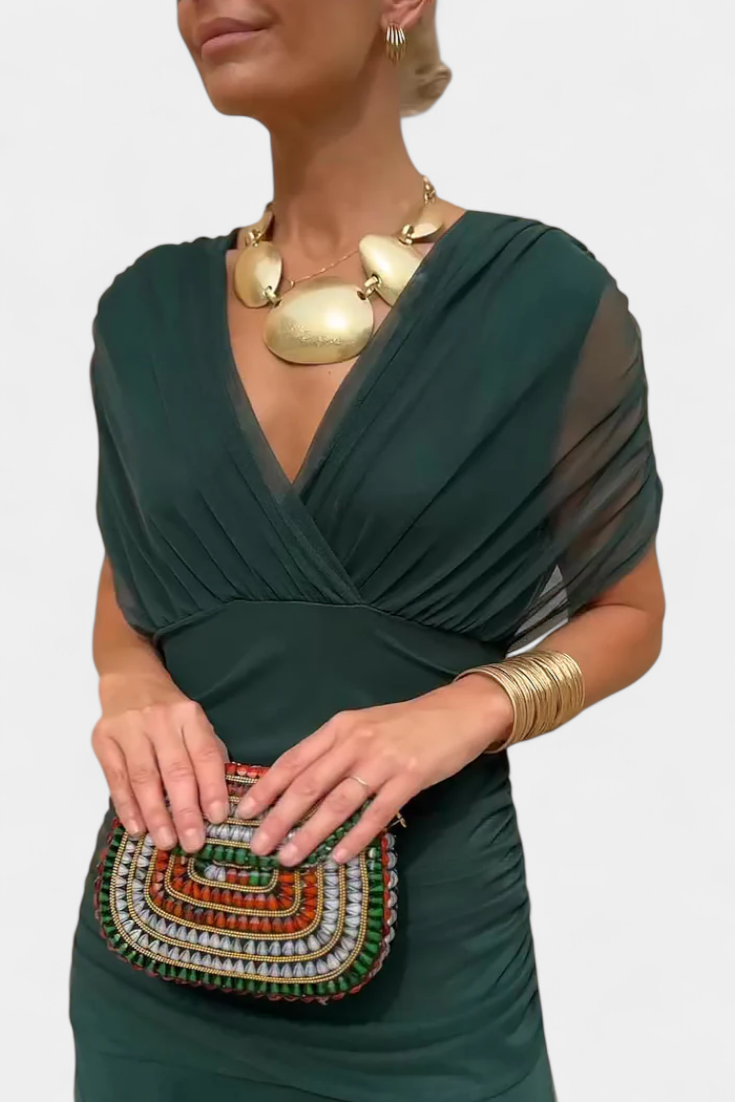 Deep green ruched maxi dress with draped v-neckline and sheer flutter sleeves, bodycon fit