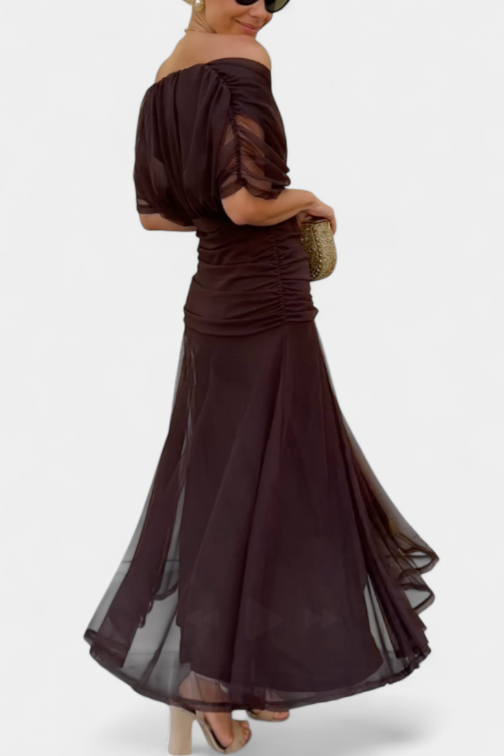 Side back view dark brown off shoulder ruched maxi dress showing gathered waist and layered sheer skirt