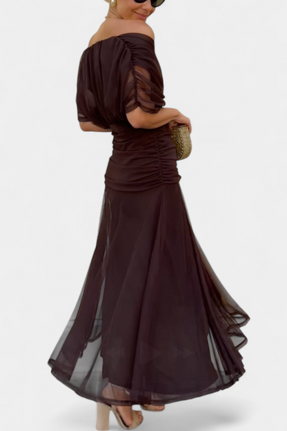 Side back view dark brown off shoulder ruched maxi dress showing gathered waist and layered sheer skirt
