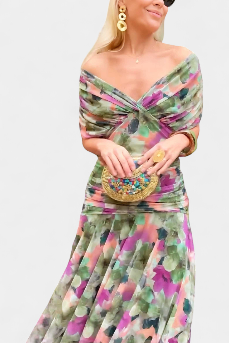 Closeup of printed off shoulder ruched maxi dress with twist neckline and multicolor floral pattern