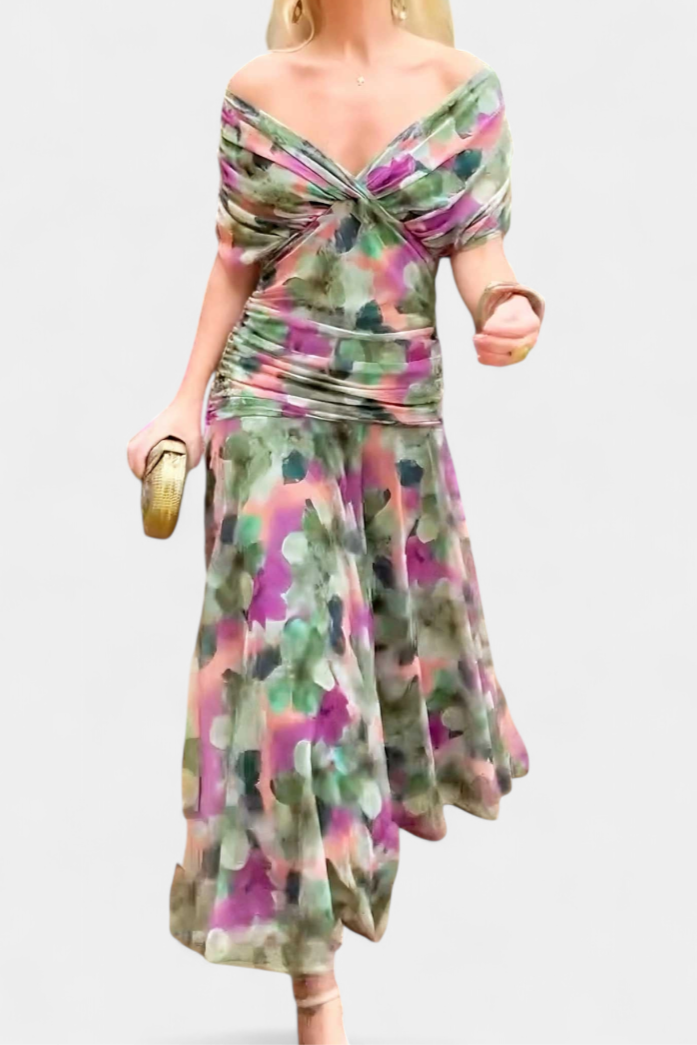 Walking view printed off shoulder ruched maxi dress with fitted ruched waist and flared maxi hem