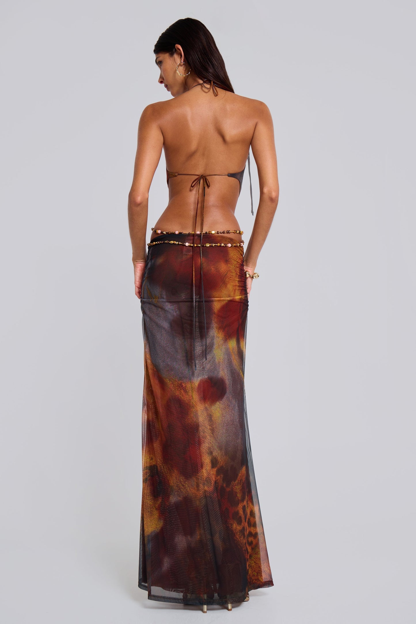 Back view of the women's printed plunge halter cut-out maxi dress, showcasing the open back and tie details, ideal for vacation dresses.