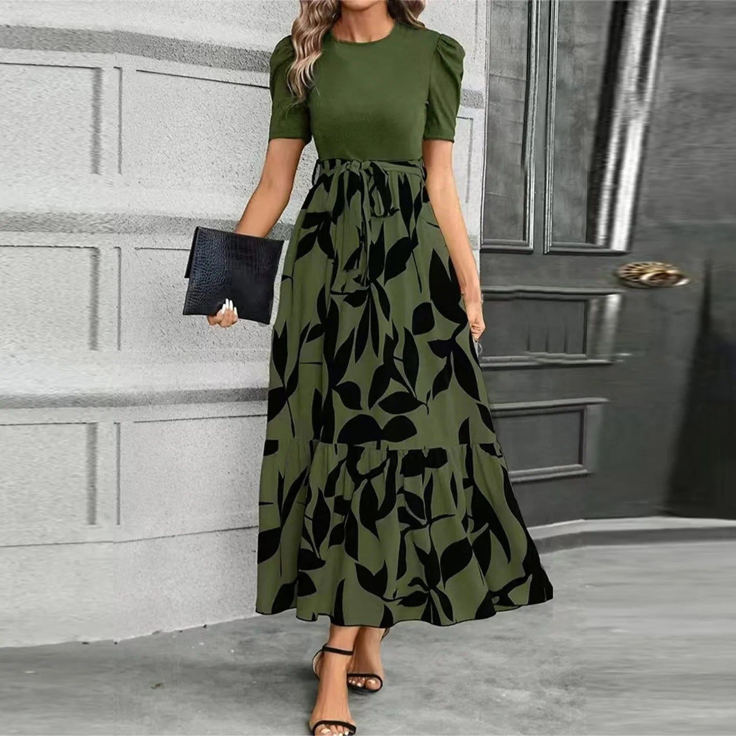 Women's stylish olive green and black leaf print maxi dress with puff sleeves and a self-tie waist, suitable for wedding guests.