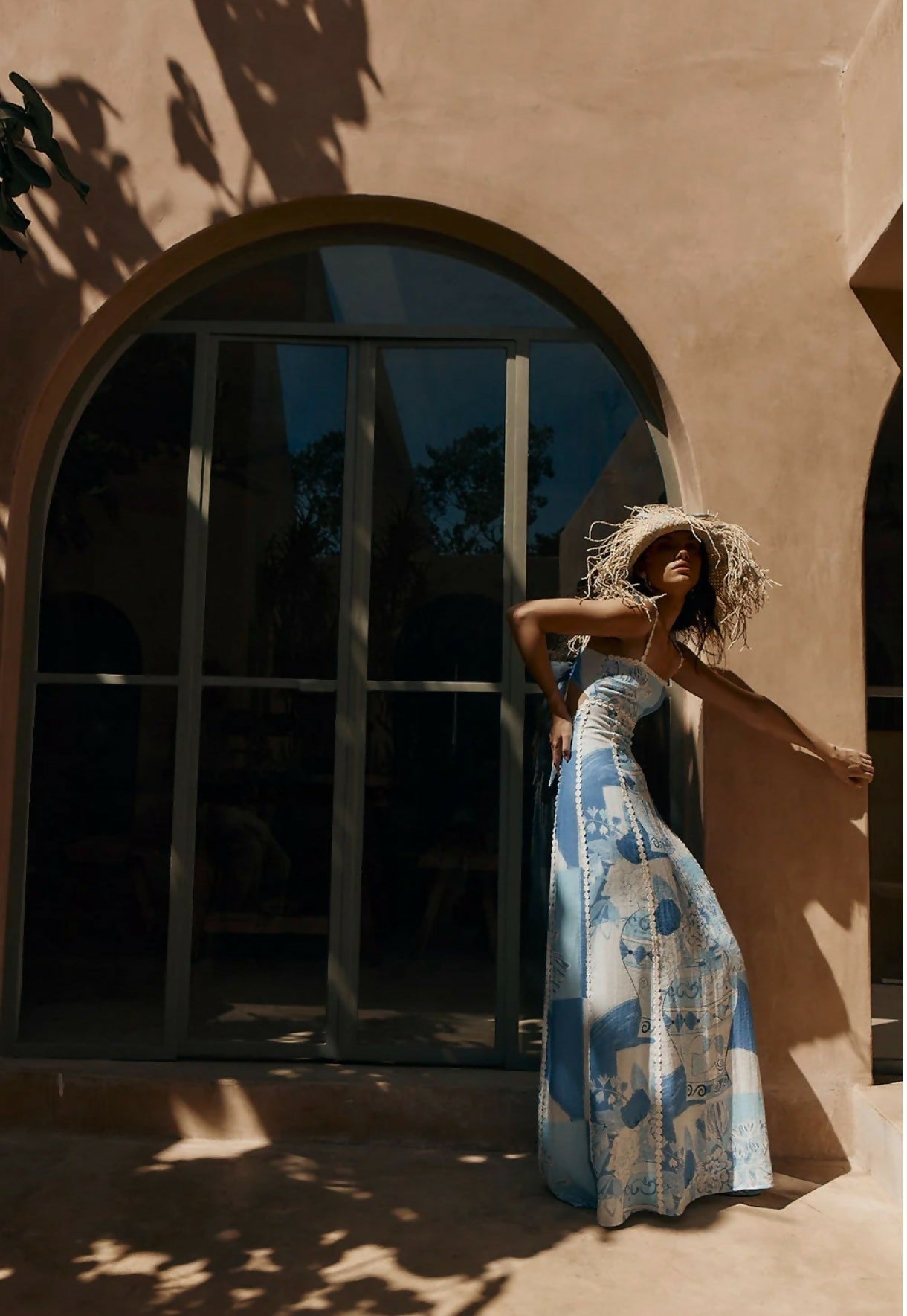 Side profile of the women's printed blue and white maxi dress with ric rac trim, showing the flow of the skirt.