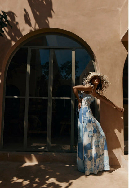 Side profile of the women's printed blue and white maxi dress with ric rac trim, showing the flow of the skirt.