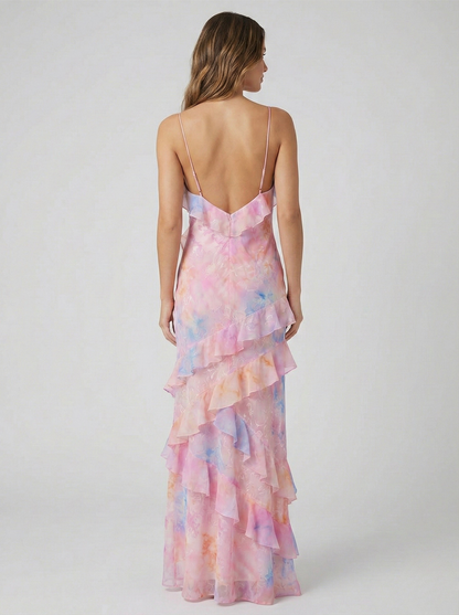 Back view of women's pink and blue ruffled maxi dress showing open back design and spaghetti straps.