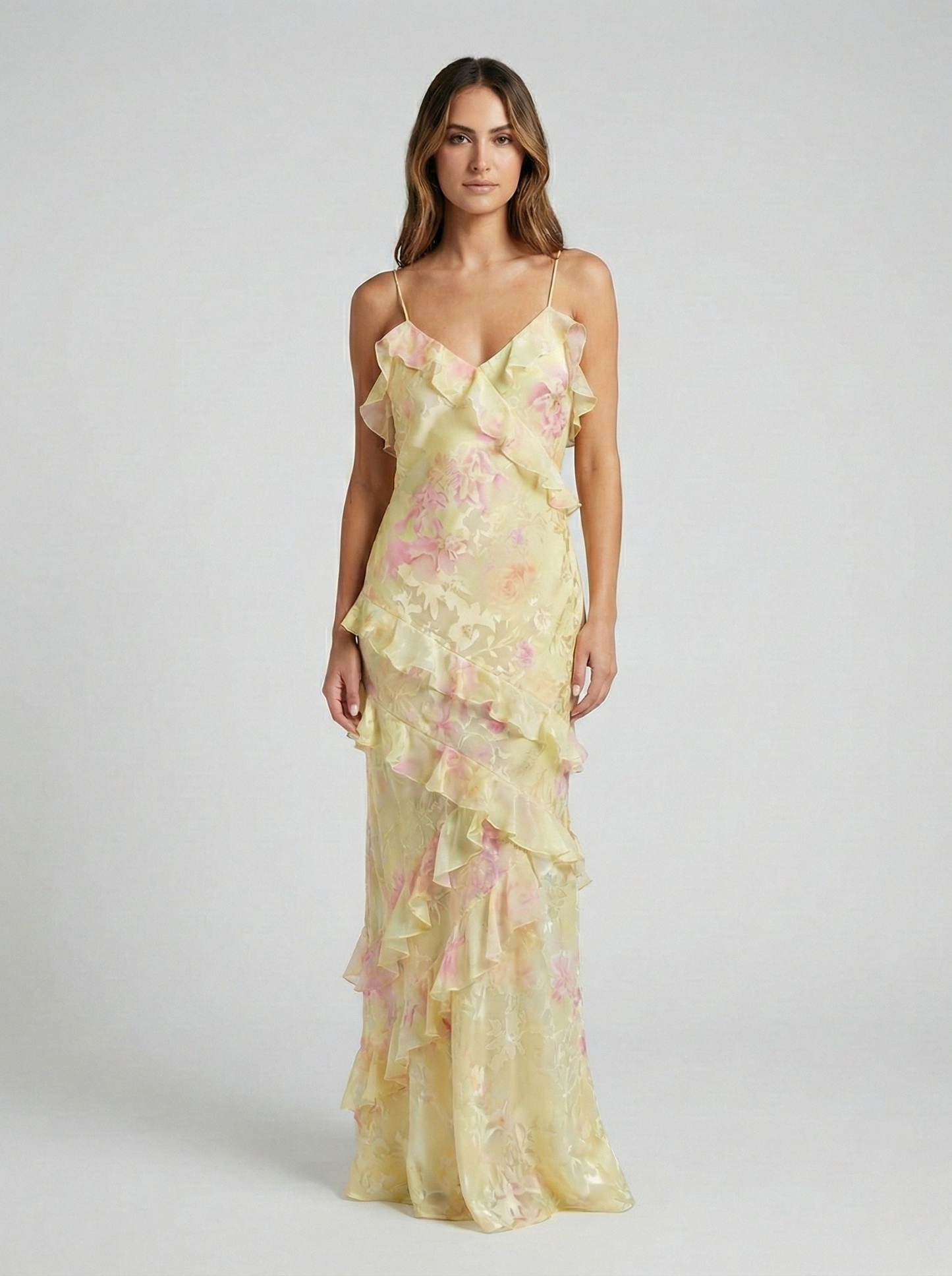 Women's yellow and pink floral maxi dress with tiered ruffles, V-neck, and thin straps.