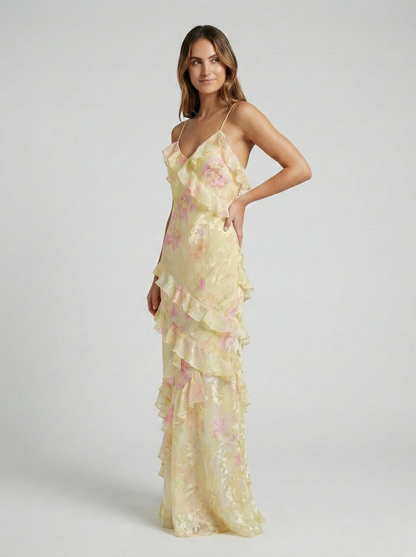 Side view of women's yellow pastel ruffled maxi dress, showing flowing skirt and V-neckline.
