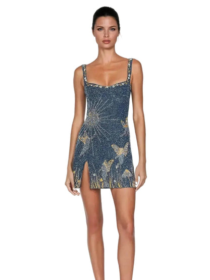 Front view of a women's navy blue mini dress with a square neck, detailed with gold sun and butterfly embroidery, on a white background.