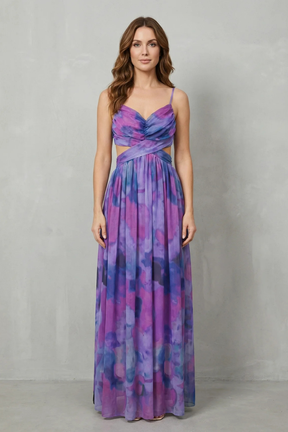 Front view of a women's elegant formal maxi dress in a purple and blue tie-dye print, with a V-neck and stylish waist cut-outs.