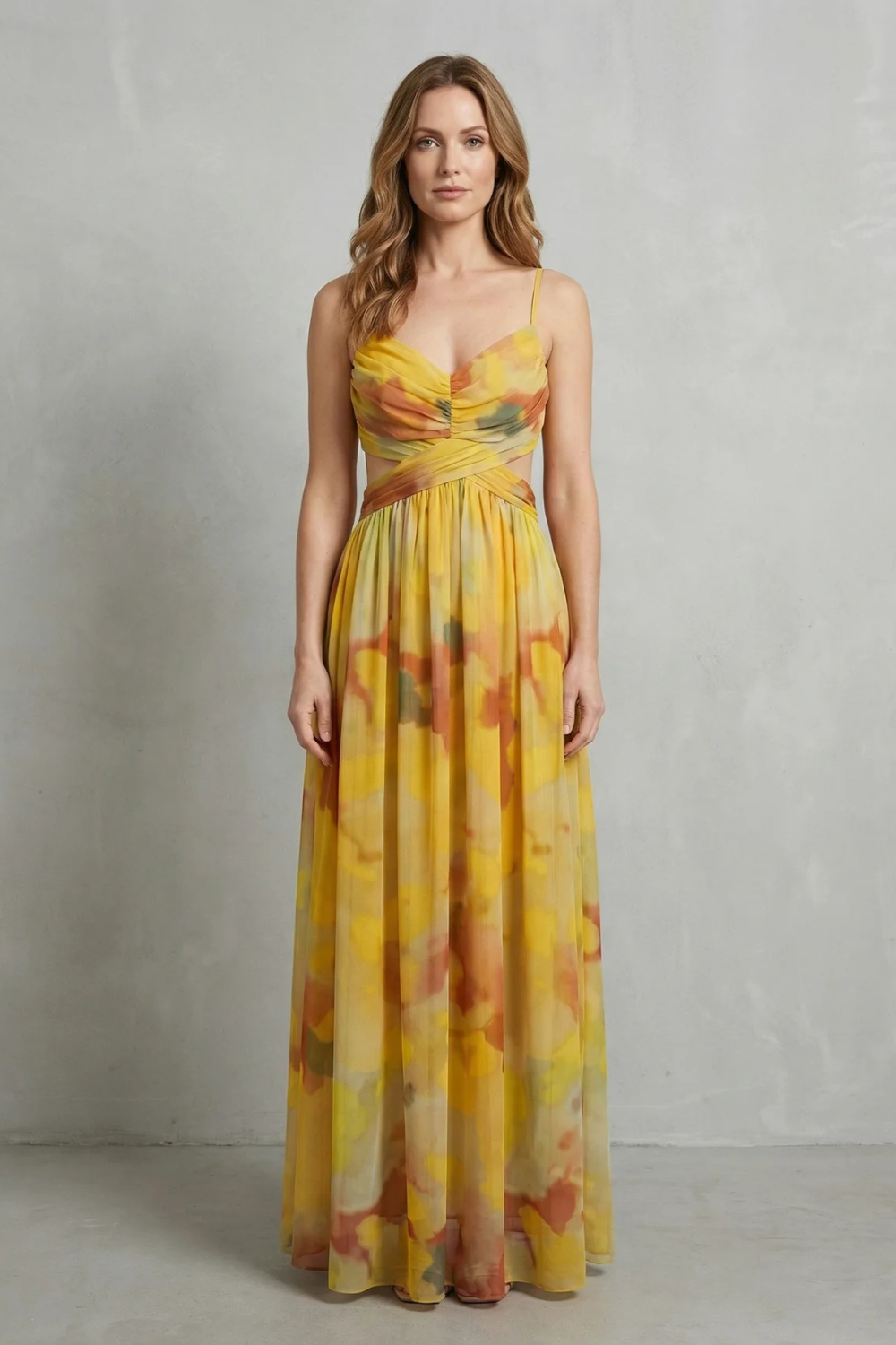 Elegant women's formal maxi dress in yellow with abstract print, V-neck, and subtle waist cut-outs.