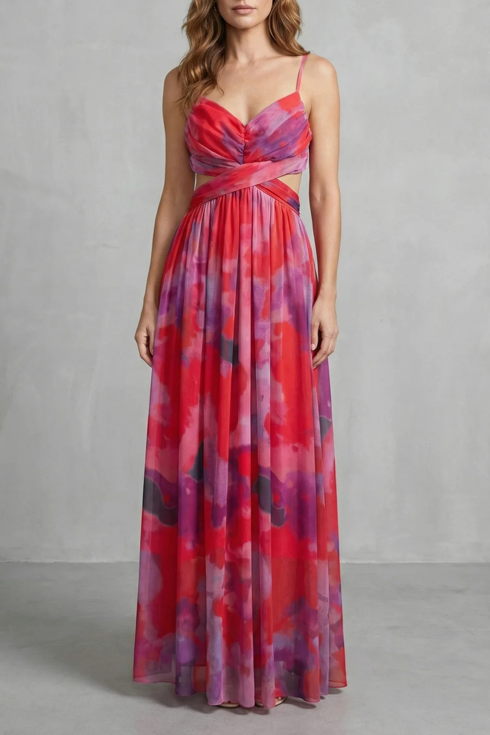 Red and purple abstract print maxi dress with V-neck, ruched bodice, and side cut-outs, perfect for vacation.