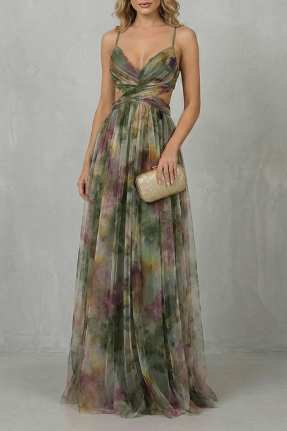 Women's formal maxi dress featuring a V-neck and cut-outs, with a green, purple, and yellow watercolor print, holding a gold clutch.