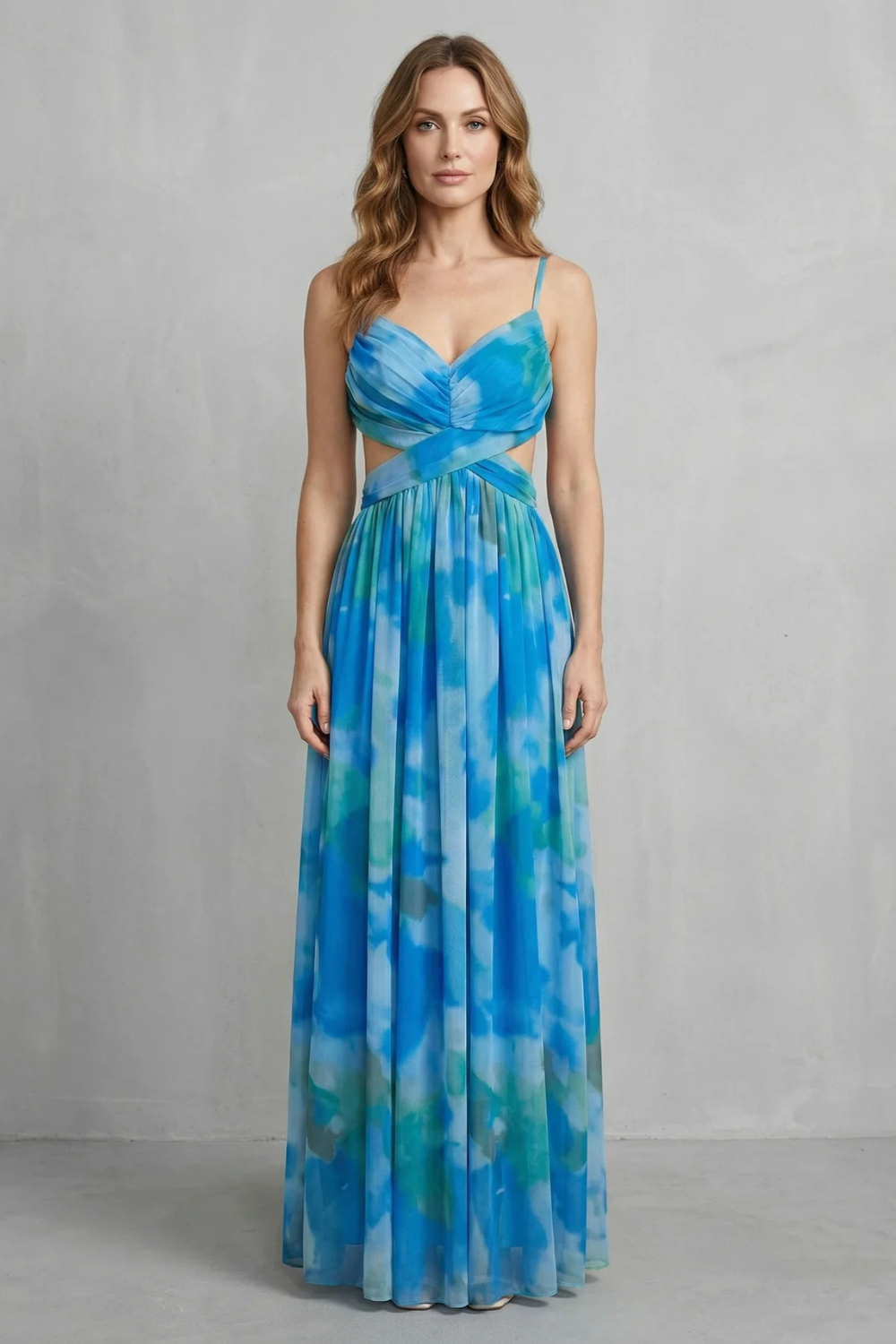 Front view of a women's elegant formal maxi dress in a blue and green tie-dye print, with a V-neck and stylish waist cut-outs.
